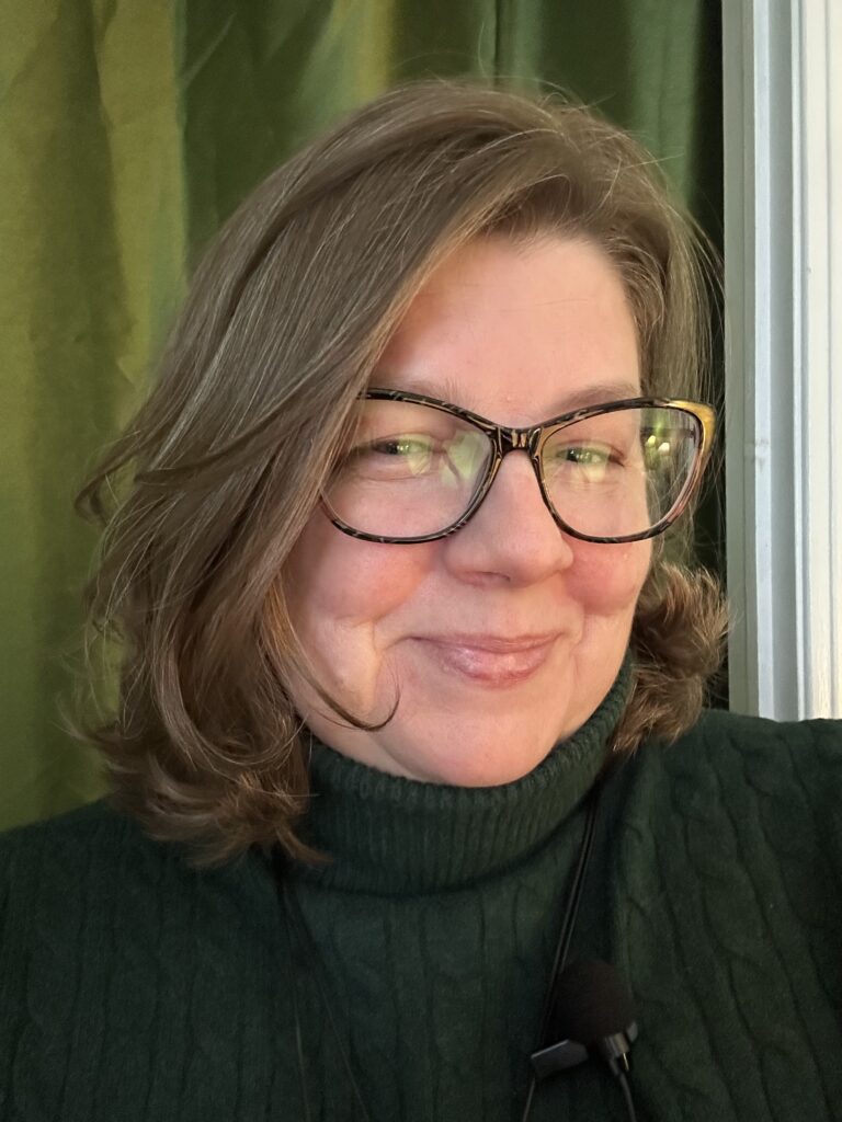 a photo selfie-style photo of a middle aged woman with light brown shoulder length hair.